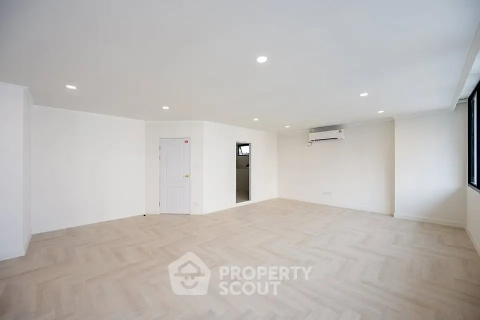 Spacious unfurnished living room with modern lighting and air conditioning