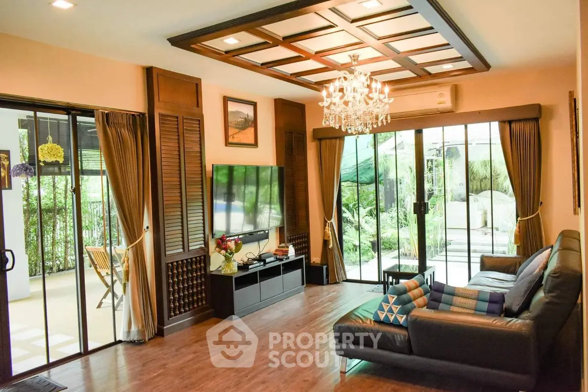 Luxurious living room with elegant chandelier and garden view