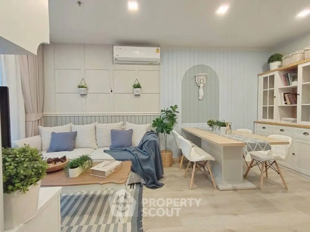Charming living room with cozy seating and elegant dining area, perfect for modern living.