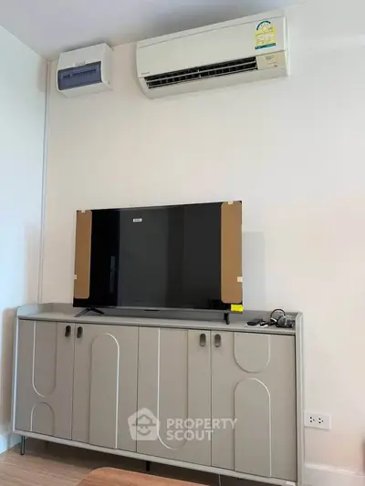 Modern living room with air conditioning and sleek TV cabinet