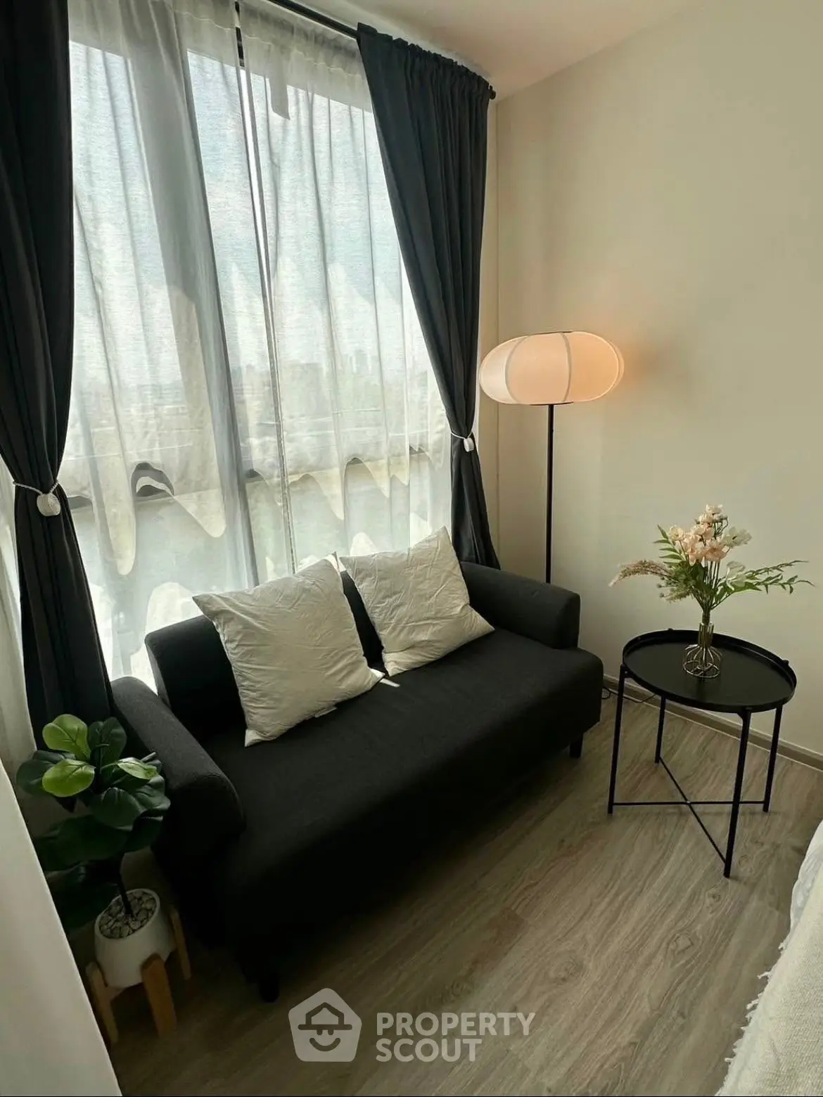 Cozy living room with modern sofa, stylish lamp, and elegant decor