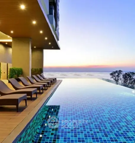 Luxurious infinity pool with ocean view at sunset, perfect for relaxation.