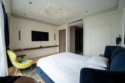 Luxurious bedroom with elegant decor and modern amenities, featuring a large bed and stylish seating area.