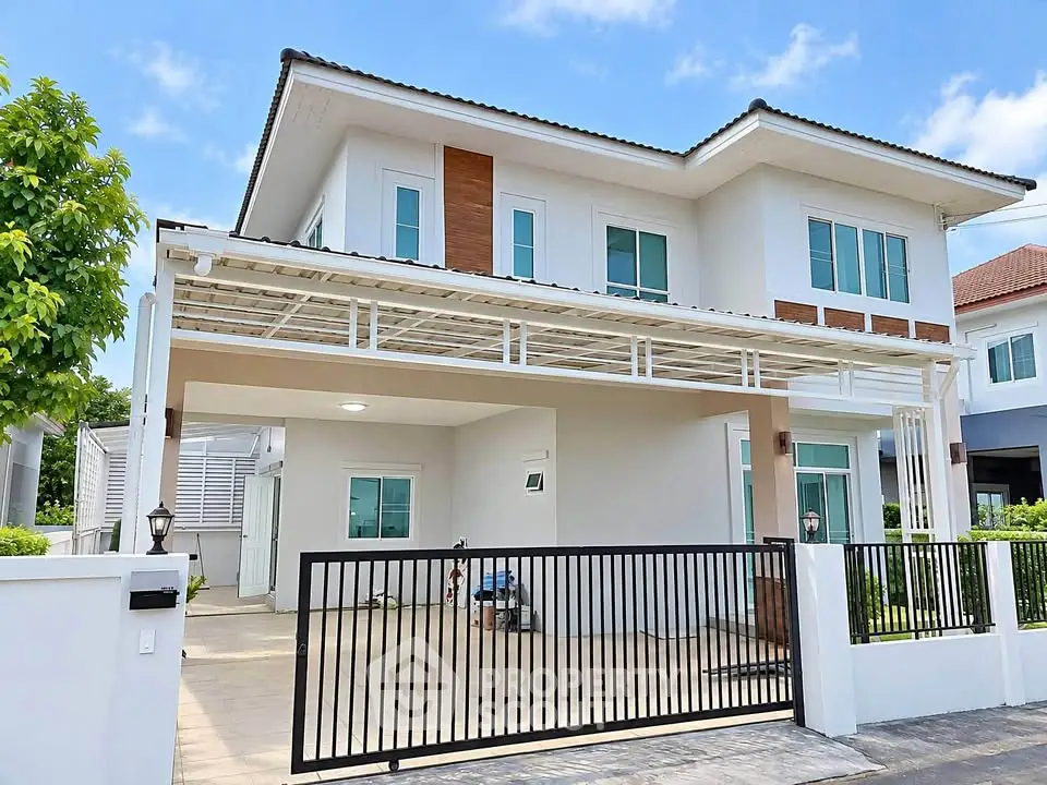 Modern two-story house with spacious driveway and sleek design in a suburban neighborhood.