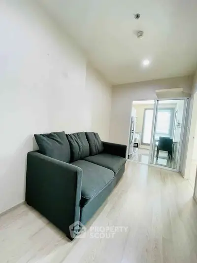 Modern living room with sleek sofa and bright natural light, perfect for cozy relaxation.