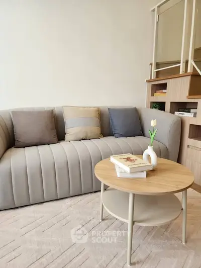 Stylish modern living room with cozy sofa and chic coffee table, perfect for relaxation and entertaining.