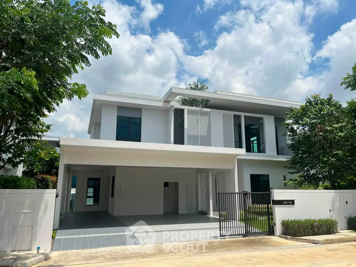 Modern two-story house with sleek design and spacious driveway in a serene neighborhood.