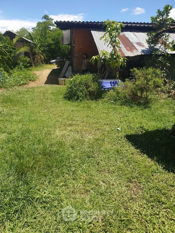 Rustic countryside home with lush green surroundings and a spacious garden, offering a serene and private living experience amidst nature.