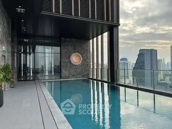 Luxurious rooftop pool with stunning city skyline views in modern high-rise building.