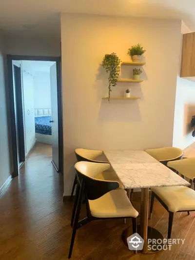 Modern dining area with marble table and stylish chairs in cozy apartment