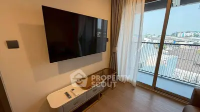 Modern living room with wall-mounted TV and balcony view