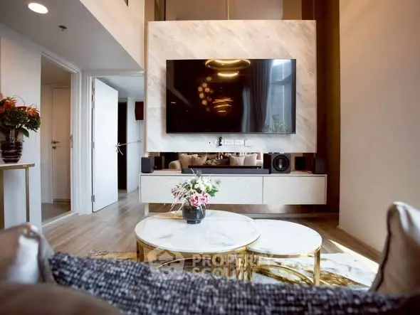 Luxurious modern living room with elegant decor and large wall-mounted TV