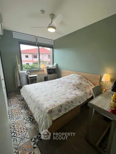 Cozy bedroom with floral bedding and stylish patterned floor tiles