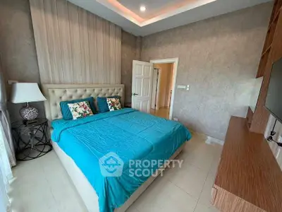Spacious bedroom with modern decor and plush bedding in a stylish home.