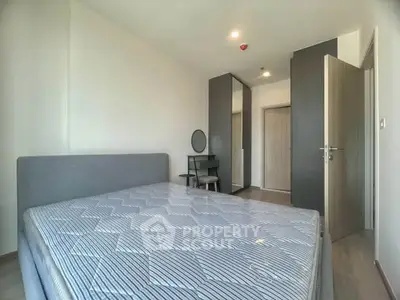 Spacious bedroom with modern furnishings and ample natural light