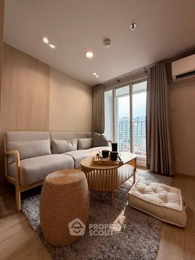 Modern living room with cozy sofa, stylish coffee table, and city view from large windows.