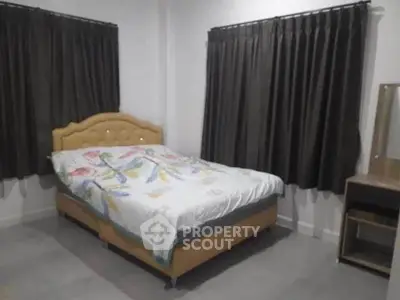 Cozy bedroom with elegant bed and dark curtains, perfect for restful nights.