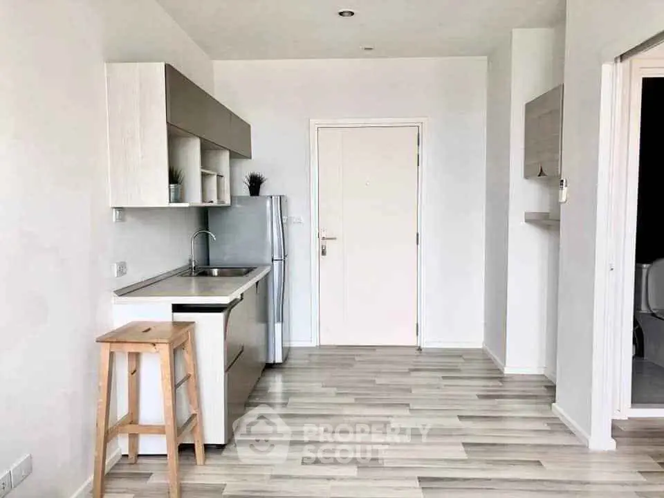 Modern minimalist kitchen with sleek cabinetry and light wood flooring, perfect for contemporary living.