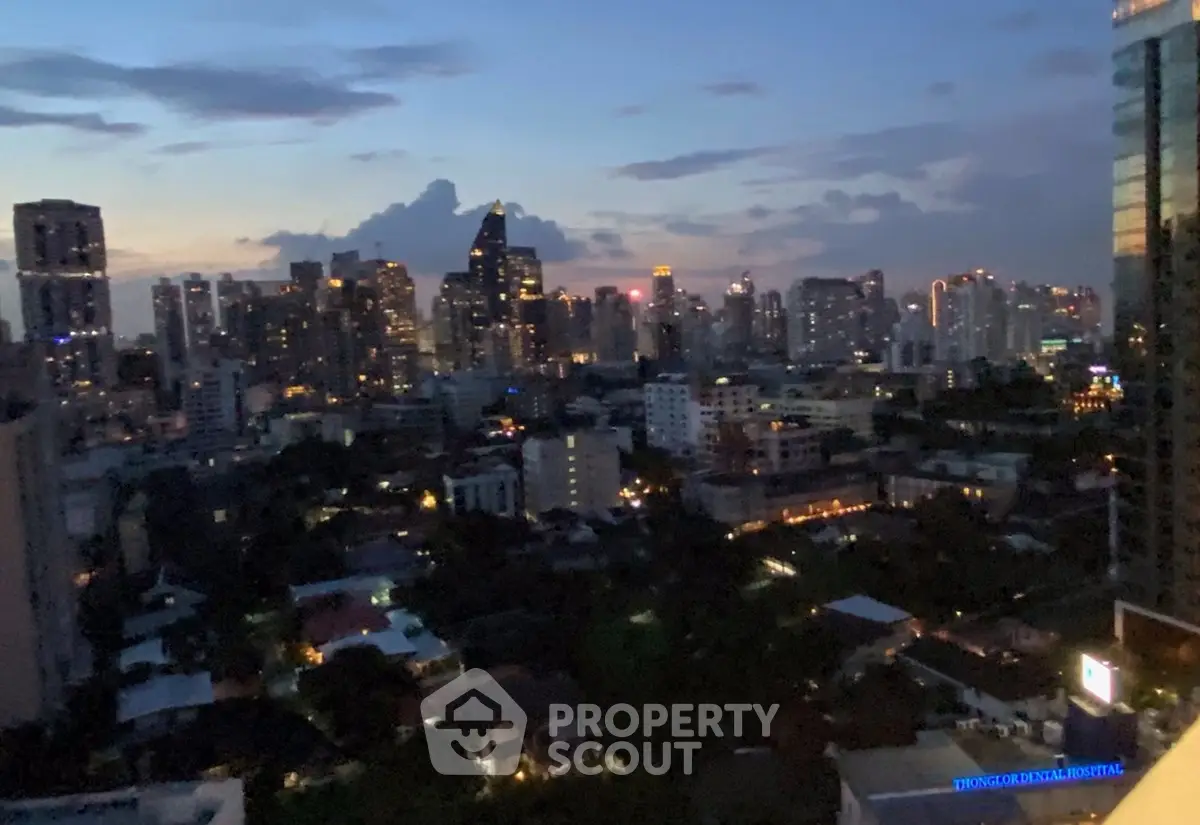 Stunning city skyline view at dusk with illuminated buildings and vibrant urban landscape.