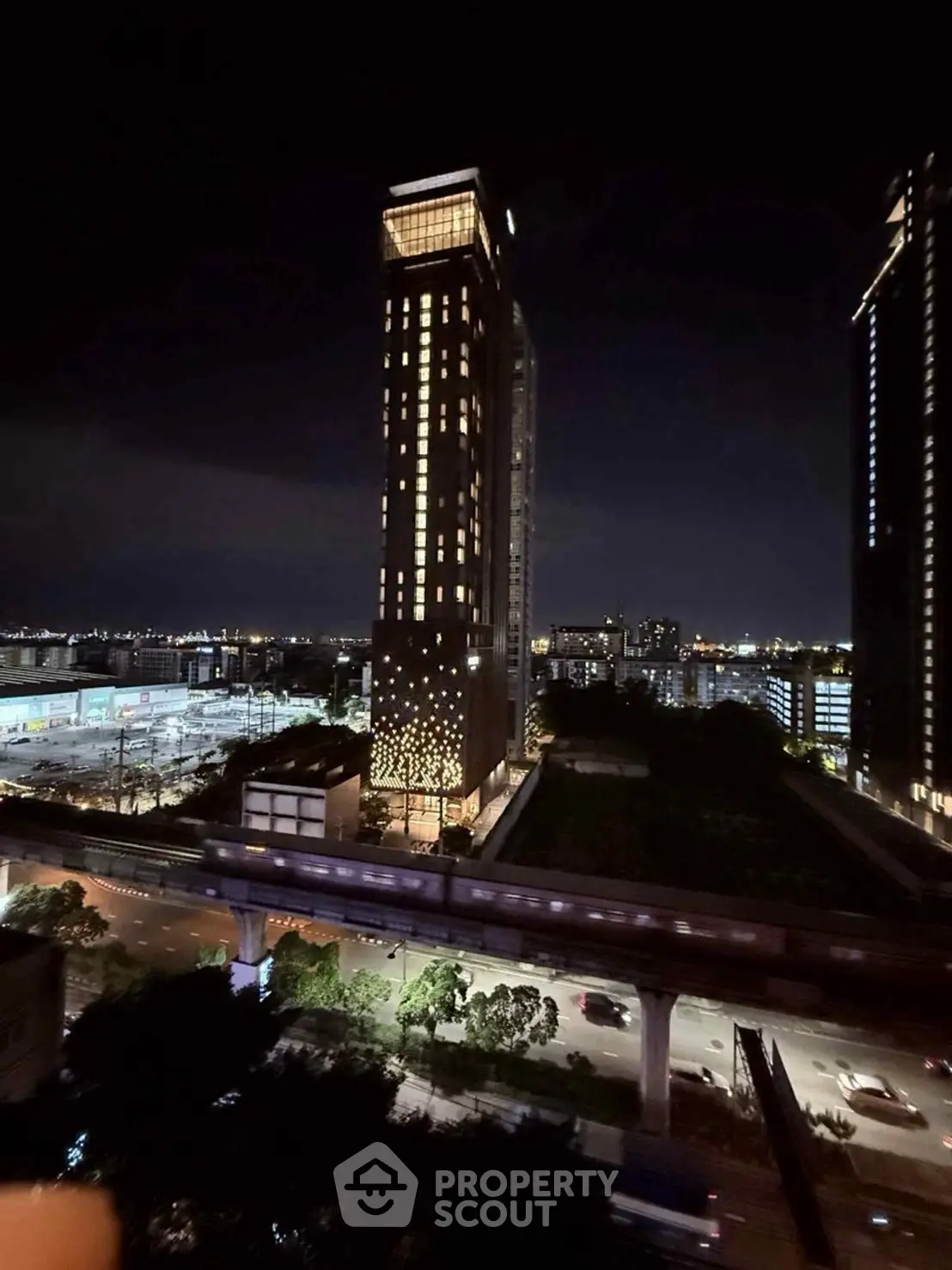 Stunning night view of illuminated high-rise building with cityscape backdrop.