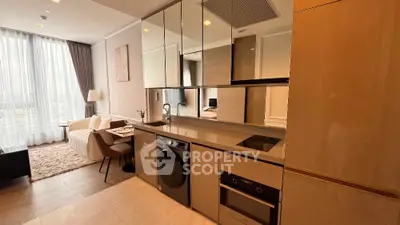 Modern open-plan kitchen with sleek appliances and cozy living area in stylish apartment