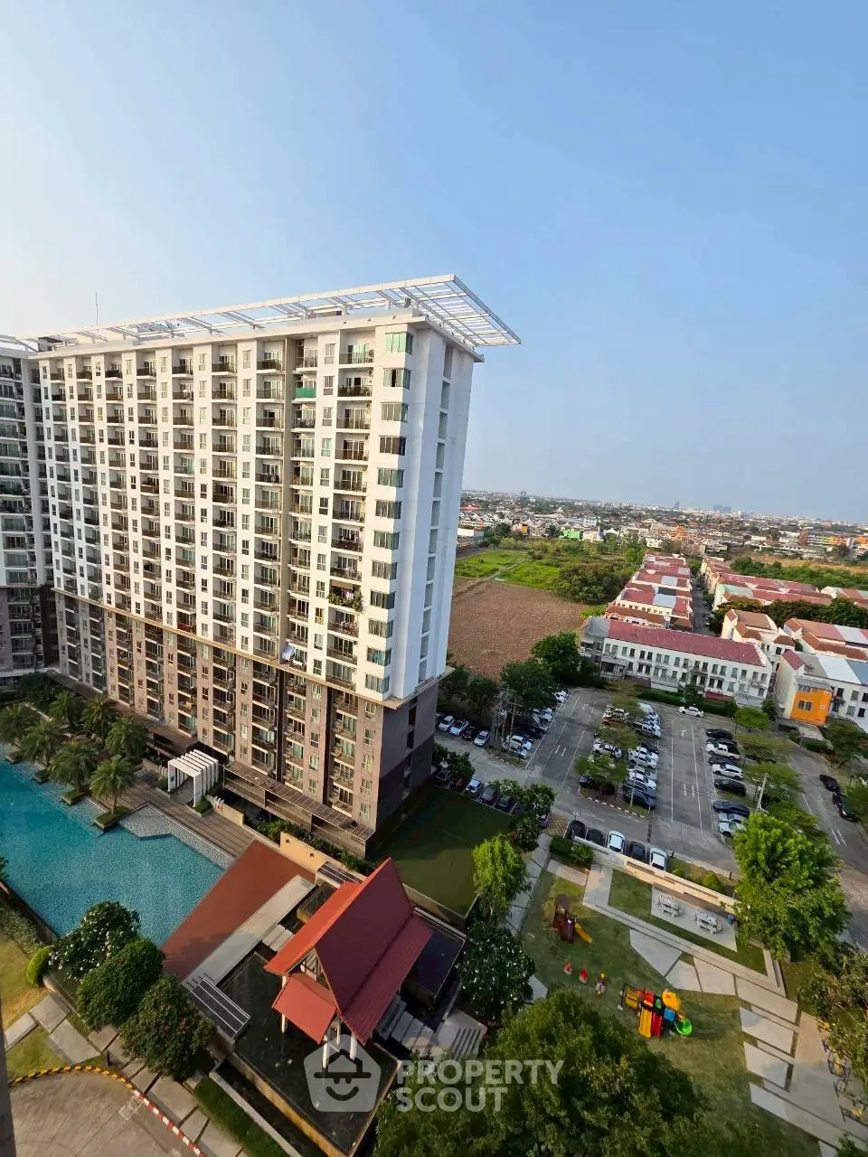 Stunning high-rise building with pool and lush surroundings, offering panoramic city views and modern amenities.