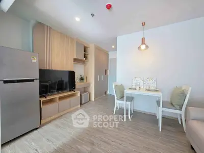 Modern living room with stylish decor and dining area in open layout apartment.