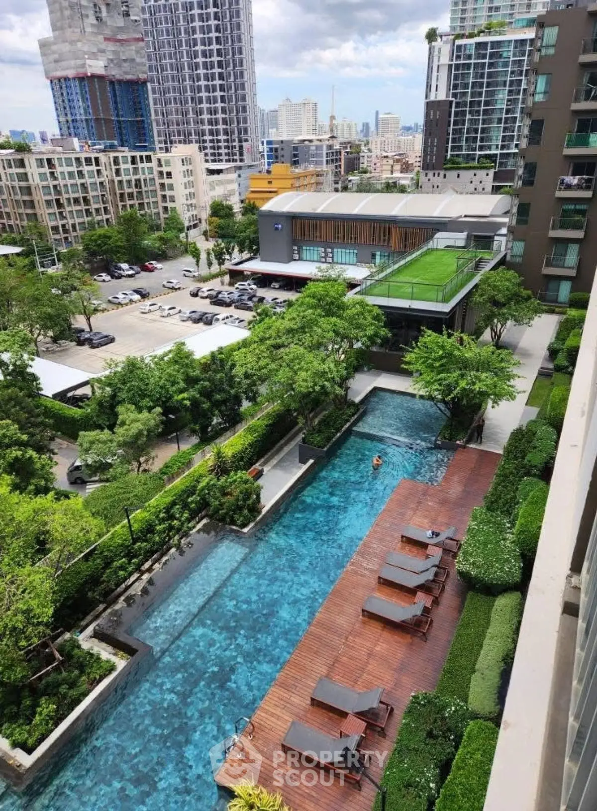 Luxurious urban apartment complex with stunning pool and lush greenery