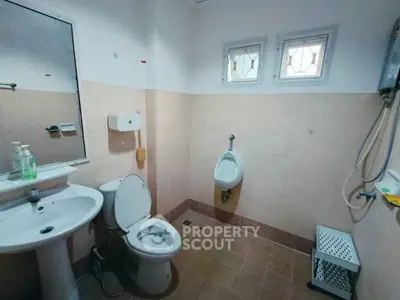 Spacious bathroom with modern fixtures and natural light.