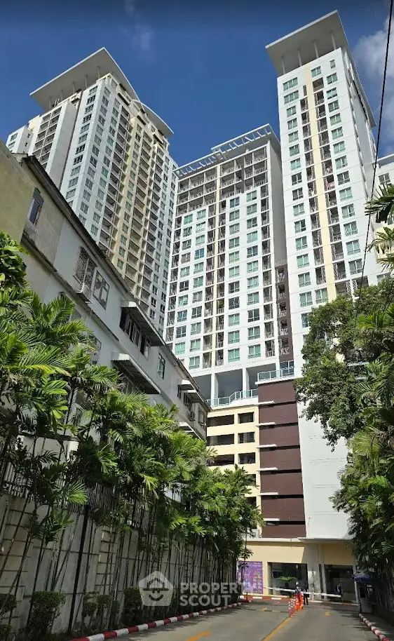 Stunning high-rise residential building with lush greenery and modern architecture.