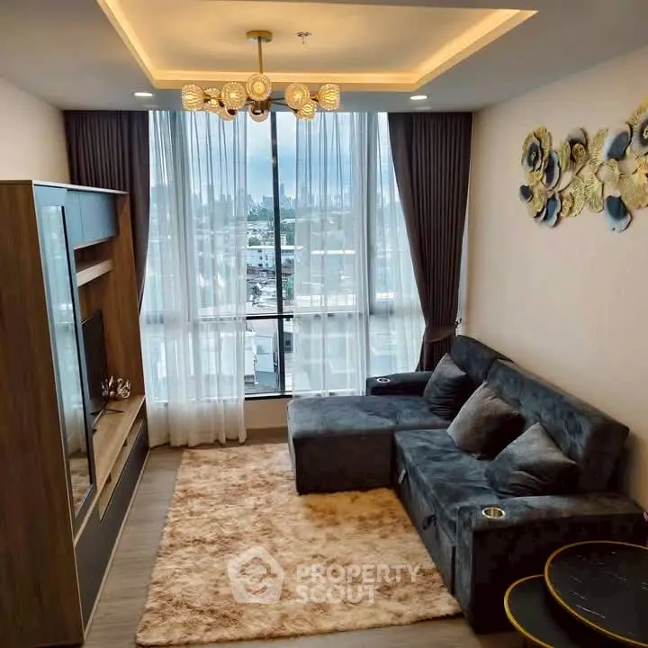 Luxurious living room with plush sofa and city view, perfect for relaxation.