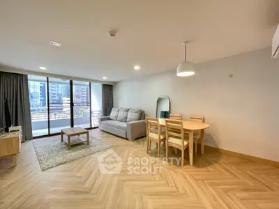 Spacious modern living room with balcony view in urban apartment