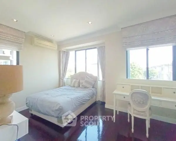 Bright and airy bedroom with elegant decor and large windows