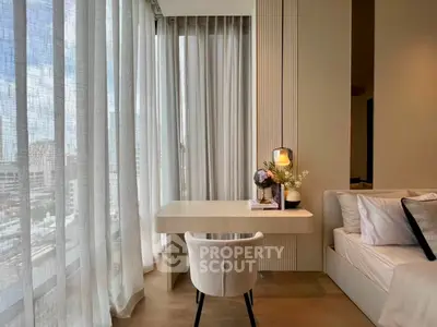 Modern study area with elegant decor and city view, featuring a sleek desk and comfortable chair.