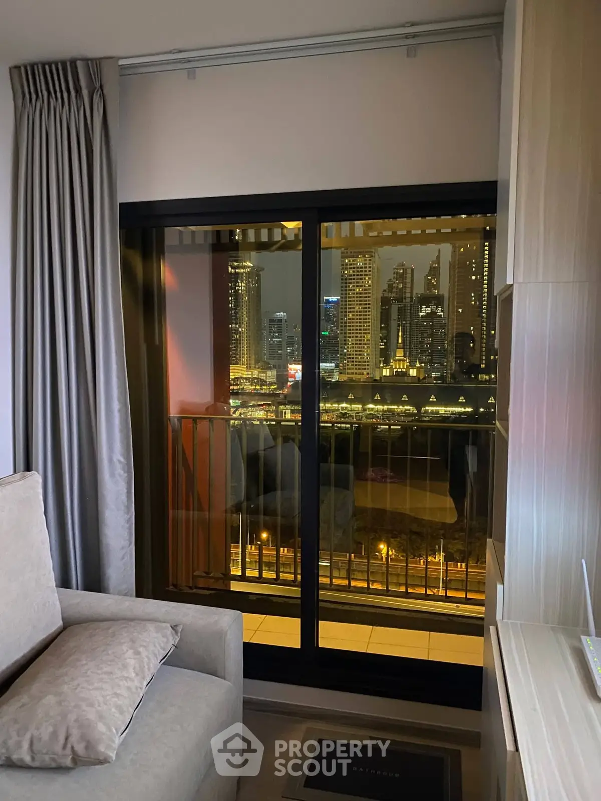 Luxurious apartment with stunning city skyline view from cozy living room balcony.
