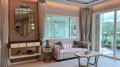 Luxurious living room with elegant decor and large windows offering garden view.