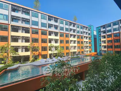 Modern apartment complex with vibrant colors and a sleek swimming pool
