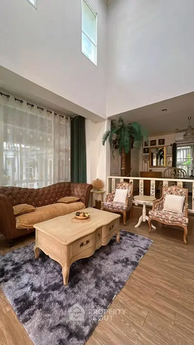 Spacious living room with high ceilings and elegant decor