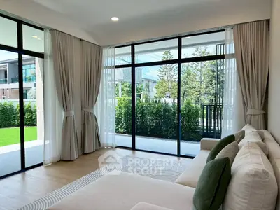 Spacious living room with large windows and garden view in modern home
