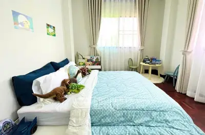 Charming bedroom with cozy decor and natural light, perfect for a child's retreat.