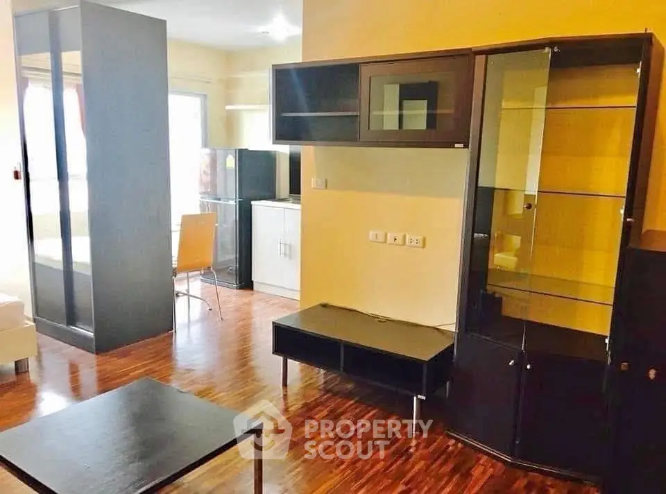 Modern living room with sleek furniture and wooden flooring in a cozy apartment.