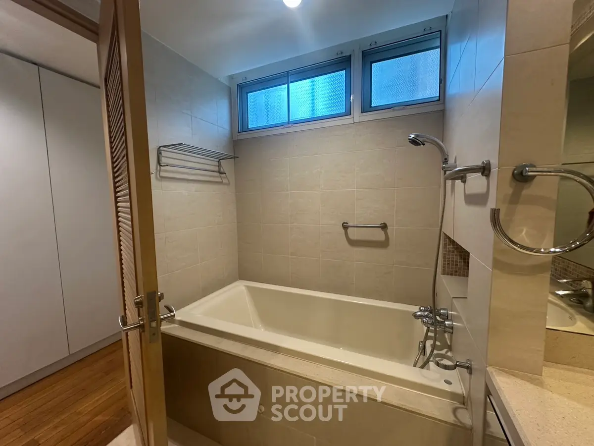 Spacious bathroom with modern bathtub and natural light