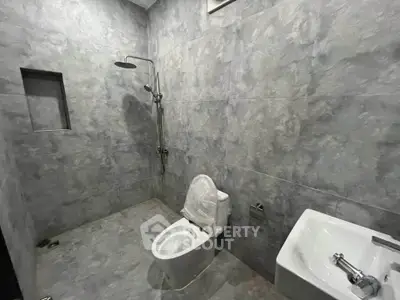 Modern bathroom with sleek gray tiles and minimalist fixtures