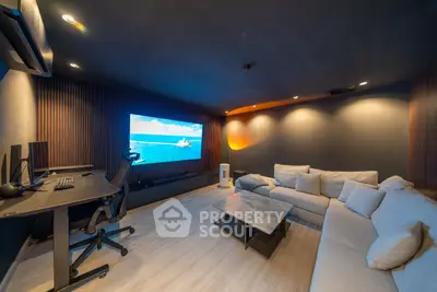 Luxurious home theater room with modern decor and large screen