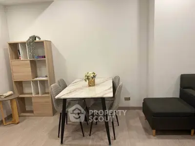 Modern dining area with elegant marble table and stylish chairs in a cozy apartment setting.