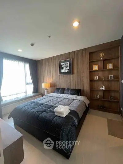 Modern bedroom with cozy decor and large window for natural light