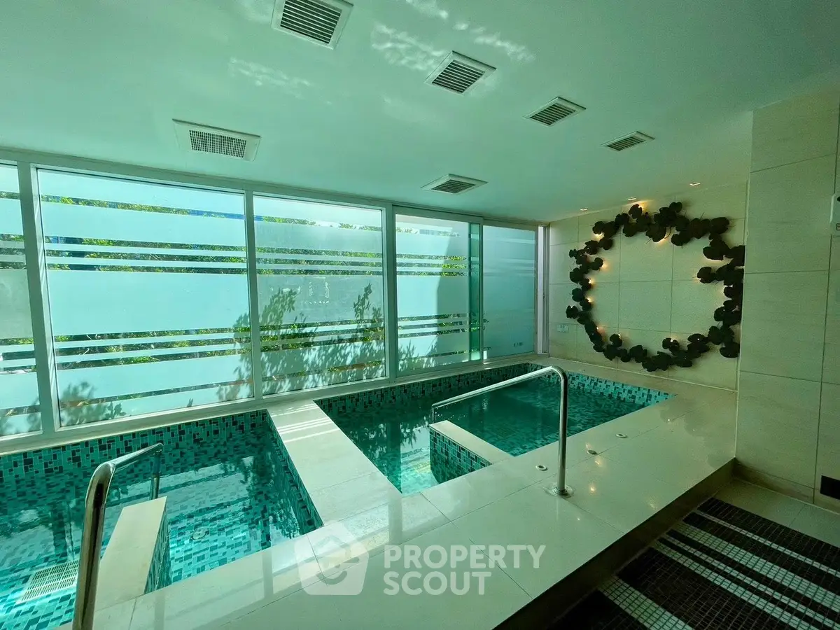 Luxurious indoor pool with modern design and natural light