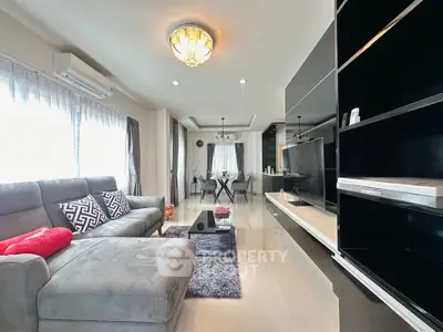 Spacious modern living room with elegant decor and ample natural light.