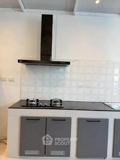 Modern kitchen with sleek black stove and stylish cabinetry
