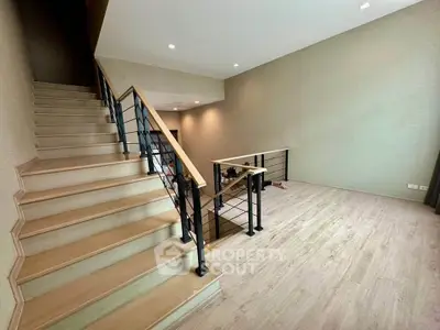 Spacious modern interior with elegant staircase and open layout, perfect for stylish living.